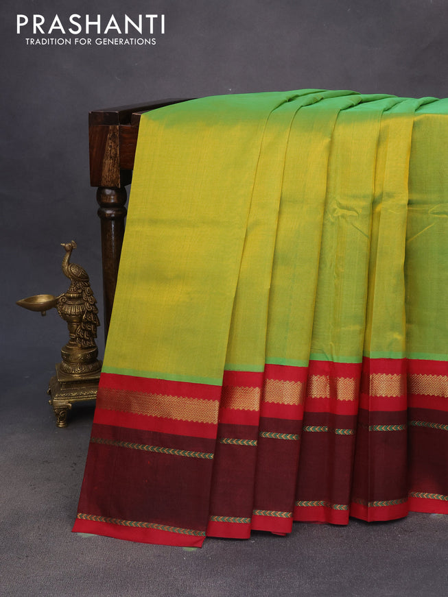 Silk cotton saree dual shade of light green and kumkum red with plain body and zari woven annam butta korvai border