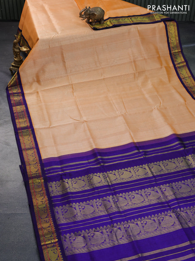 Silk cotton saree pale orange and blue with plain body and paisley zari woven korvai border