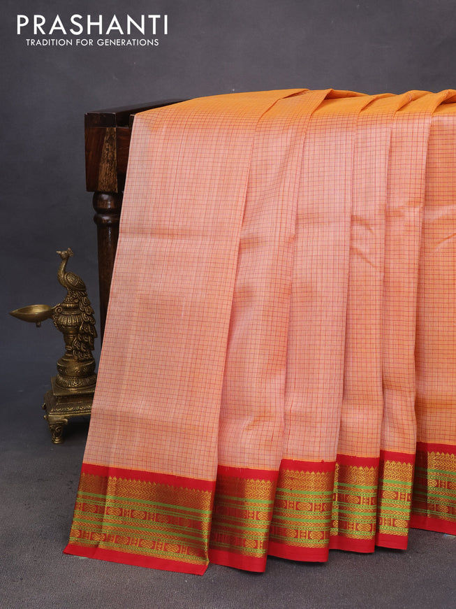 Silk cotton saree peach orange and red with allover checked pattern and zari woven korvai border