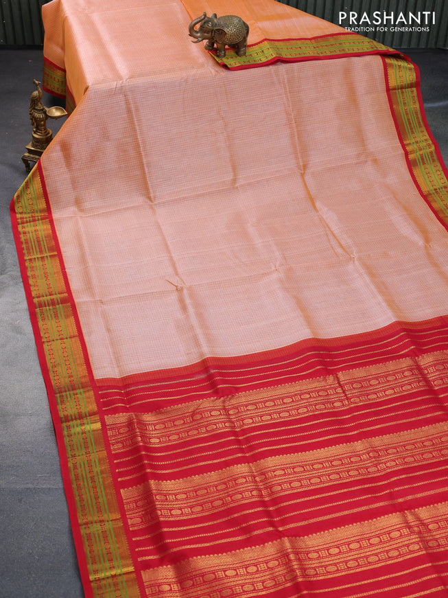 Silk cotton saree peach orange and red with allover checked pattern and zari woven korvai border