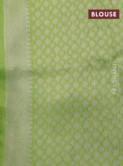 Banarasi raw silk saree fluorescent green with thread & zari woven floral buttas and long floral zari woven paithani border