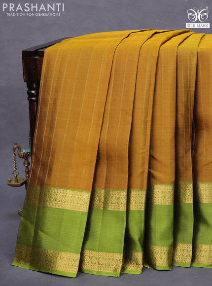 Pure soft silk saree dark mustard and light green with allover zari stripe weaves and long rettapet zari woven border