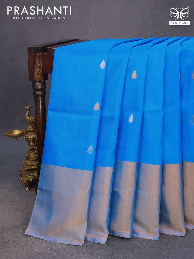 Pure uppada silk saree cs blue and pastel peach shade with silver & gold zari woven tilak buttas and long zari woven border