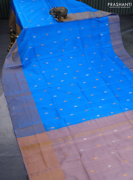 Pure uppada silk saree cs blue and pastel peach shade with silver & gold zari woven tilak buttas and long zari woven border