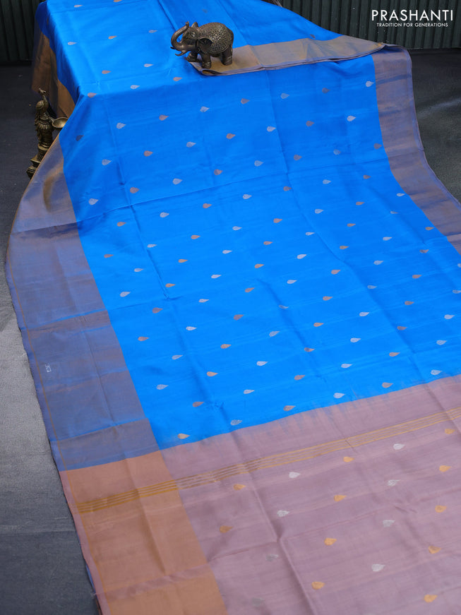 Pure uppada silk saree cs blue and pastel peach shade with silver & gold zari woven tilak buttas and long zari woven border