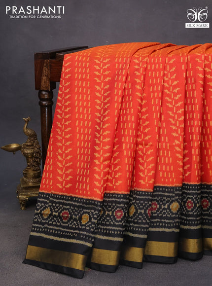 Rajkot patola silk saree dual shade of pinkish orange and black with allover ikat weaves and ikat woven zari border