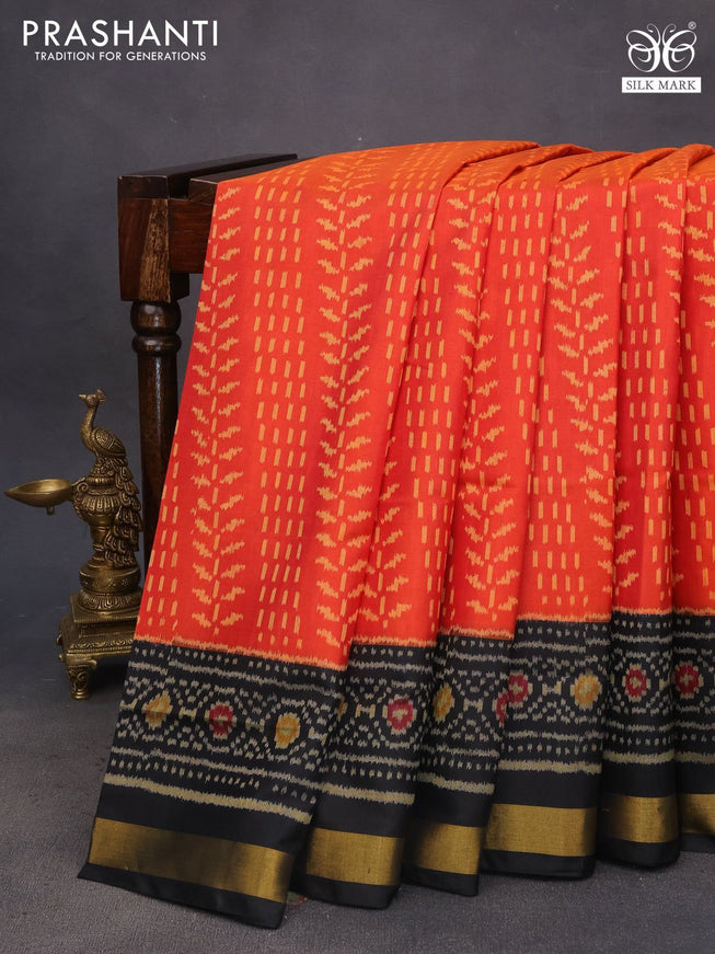 Rajkot patola silk saree dual shade of pinkish orange and black with allover ikat weaves and ikat woven zari border