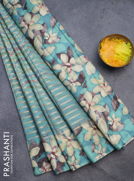 Semi tussar saree teal green shade with allover zari woven veldhari design & prints and floral printed border