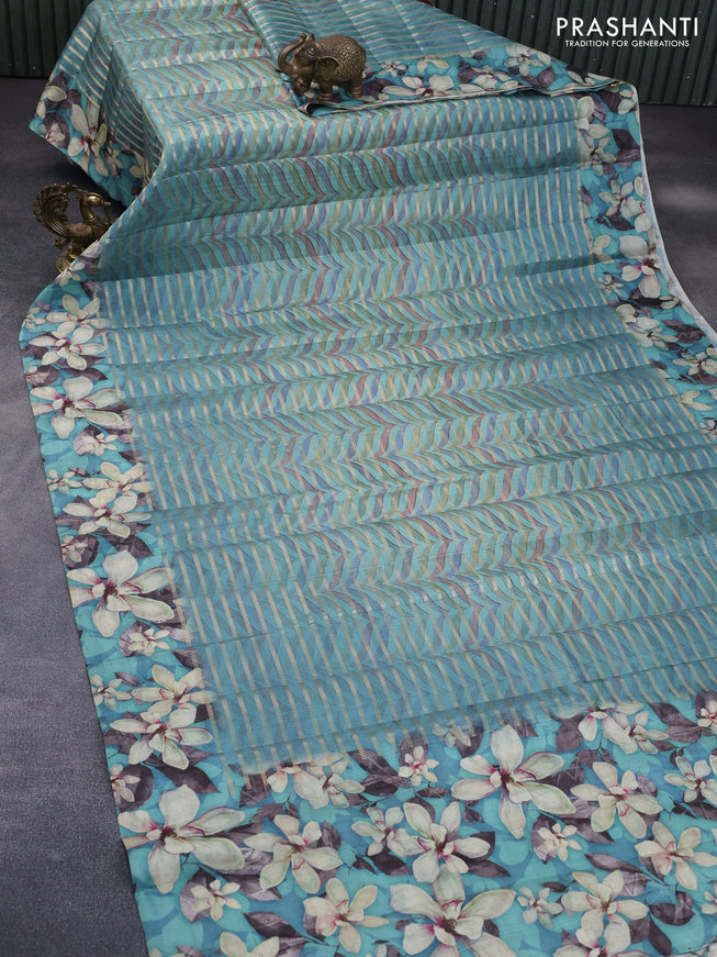 Semi tussar saree teal green shade with allover zari woven veldhari design & prints and floral printed border