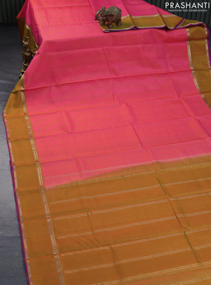 Pure kanchipuram silk saree dual shade of pinkish orange and violet with allover stripes pattern and rettapet zari woven border