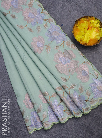 Semi raw silk saree pastel green shade with embroidery work buttas and floral design embroidery work border