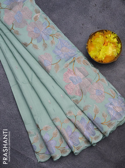 Semi raw silk saree pastel green shade with embroidery work buttas and floral design embroidery work border