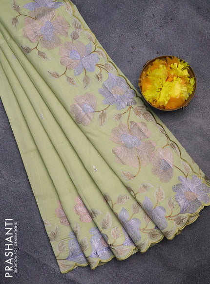 Semi raw silk saree mild pista green with embroidery work buttas and floral design embroidery work border