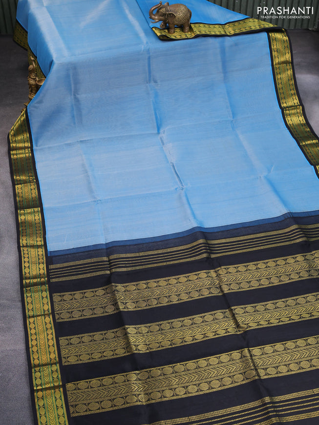 Silk cotton saree light blue and black with plain body and zari woven korvai border