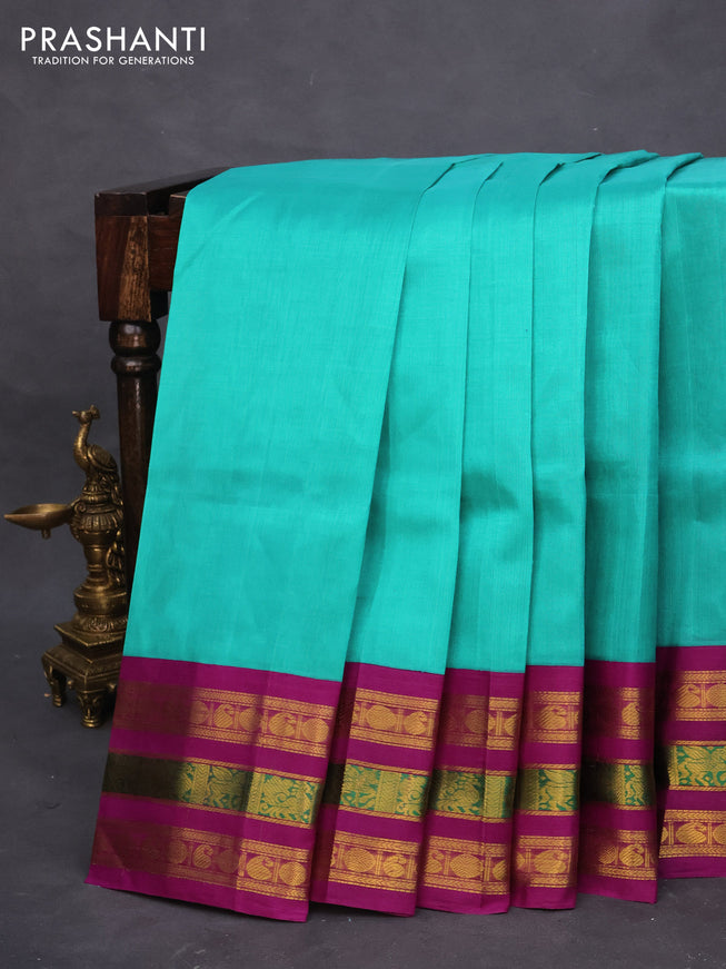 Silk cotton saree teal blue and purple with plain body and long zari woven korvai border