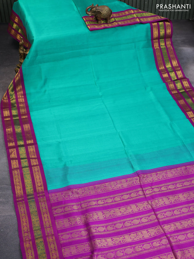 Silk cotton saree teal blue and purple with plain body and long zari woven korvai border