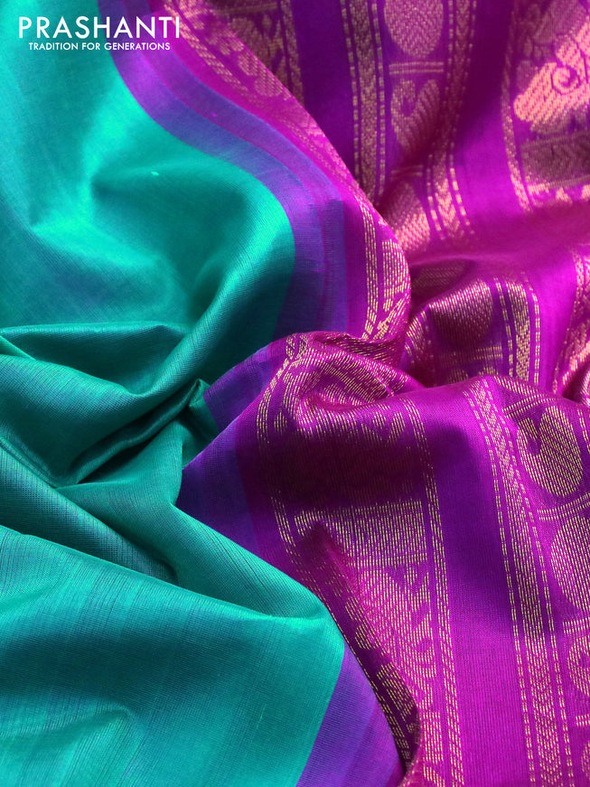 Silk cotton saree teal blue and purple with plain body and long zari woven korvai border