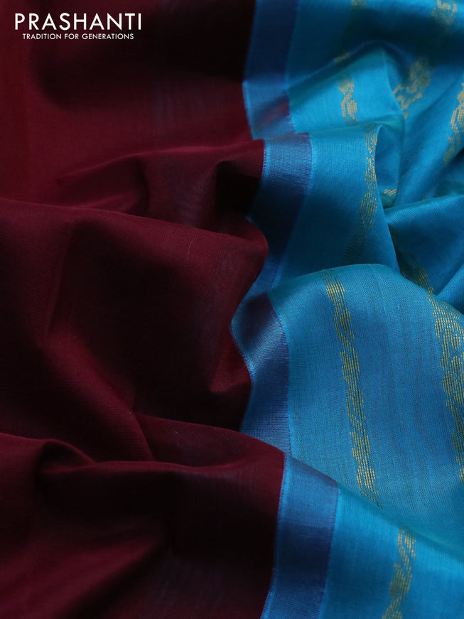 Silk cotton saree maroon and light blue with plain body and zari woven korvai border