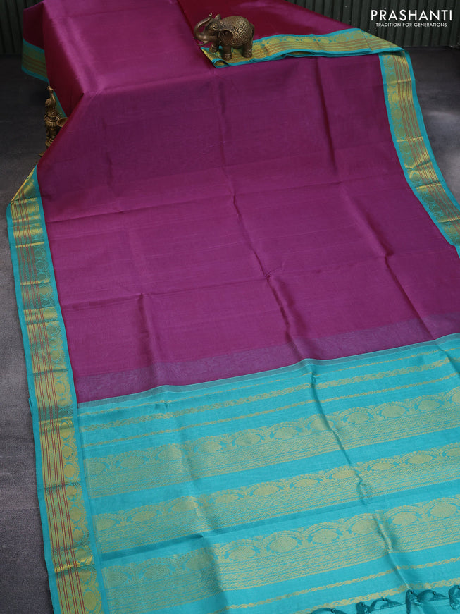 Silk cotton saree purple shade and teal blue with plain body and zari woven korvai border