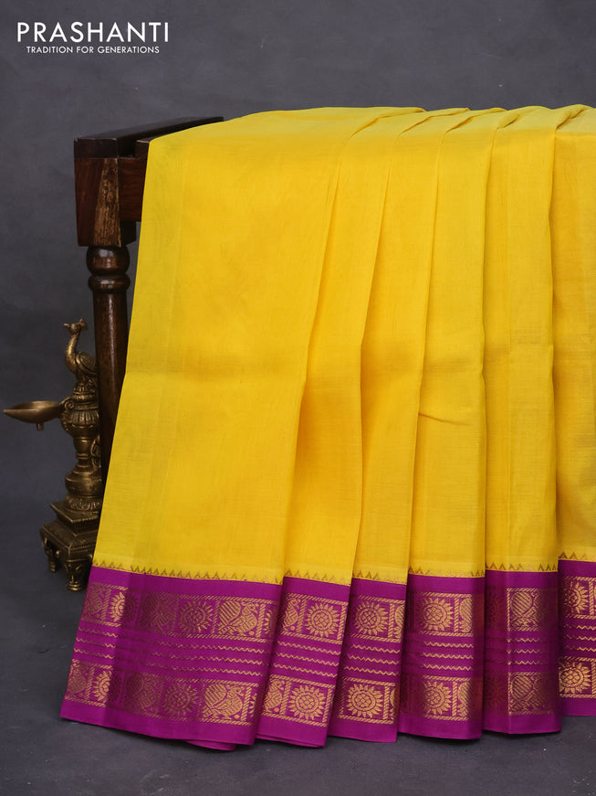 Silk cotton saree yellow and purple with plain body and zari woven korvai border