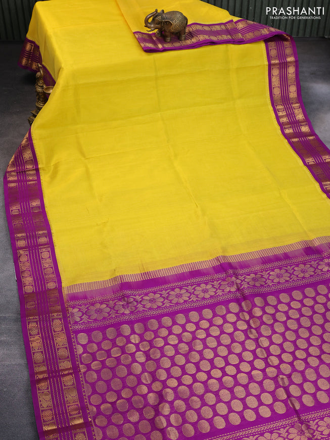 Silk cotton saree yellow and purple with plain body and zari woven korvai border