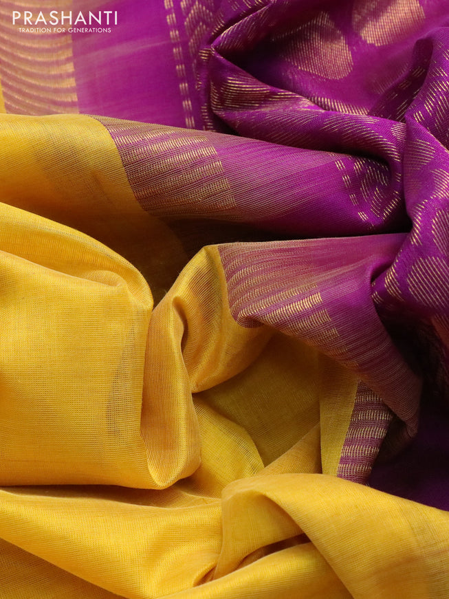 Silk cotton saree yellow and purple with plain body and zari woven korvai border