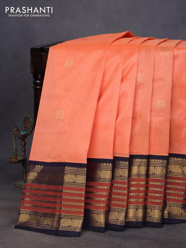 Silk cotton saree peach orange and navy blue with elephant zari woven buttas and long zari woven korvai border