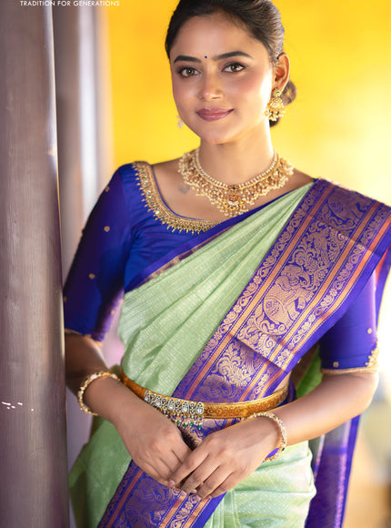 Kuppadam silk cotton saree teal green and blue with allover zari checks & buttas and temple deisgn zari woven border