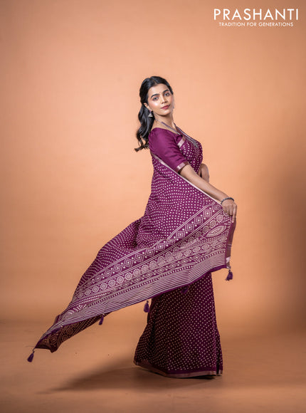 Semi georgette saree wine shade with allover bandhani prints and zari woven border