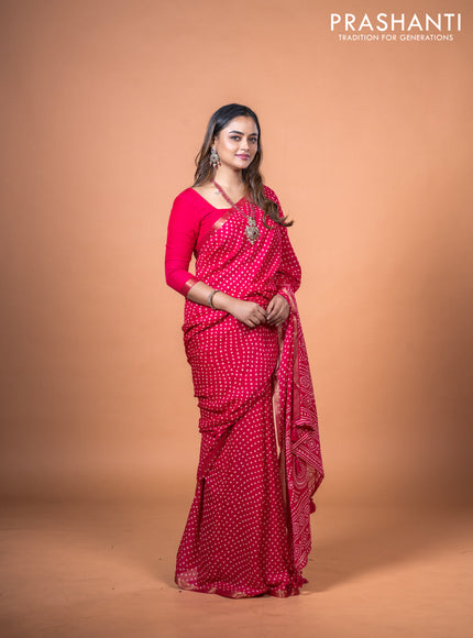 Semi georgette saree pink with allover bandhani prints and zari woven border