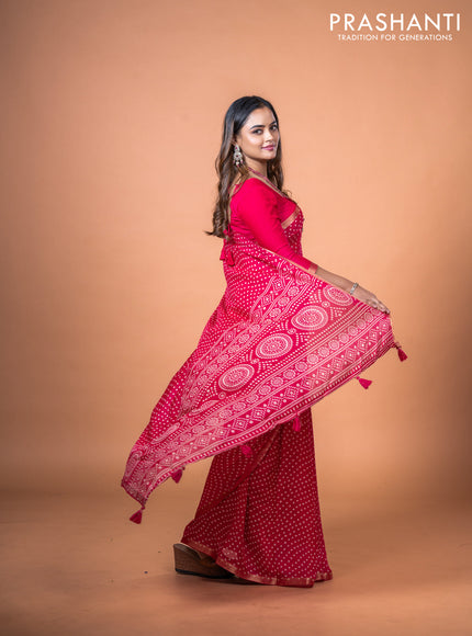 Semi georgette saree pink with allover bandhani prints and zari woven border