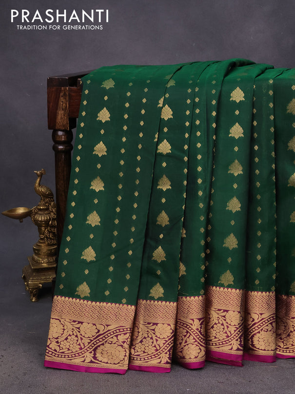 Kanchipuram silk saree dark green and dark magenta pink with allover zari woven buttas and floral zari woven border