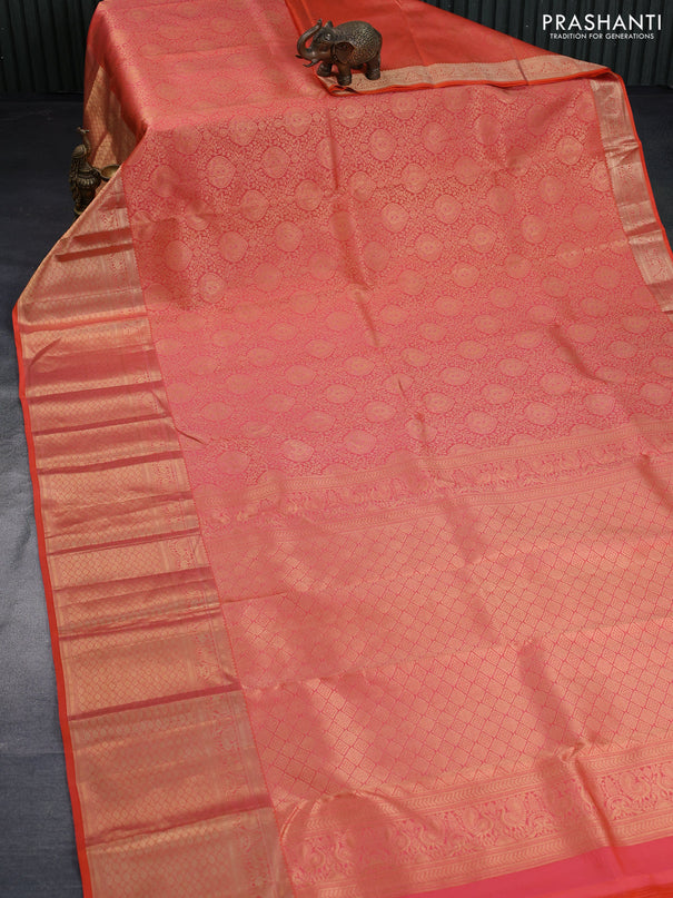 Pure kanchipuram silk saree dual shade of pinkish orange with allover zari woven brocade weaves and long annam zari woven border