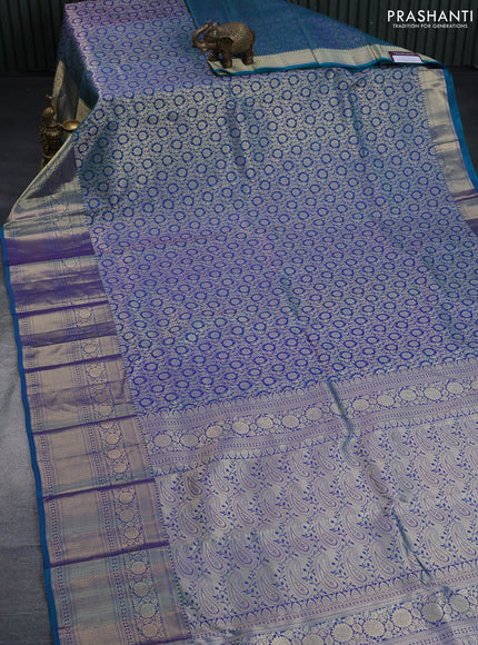 Pure kanchipuram silk saree dual shade of peacock blue with allover zari woven brocade weaves and long floral zari woven border