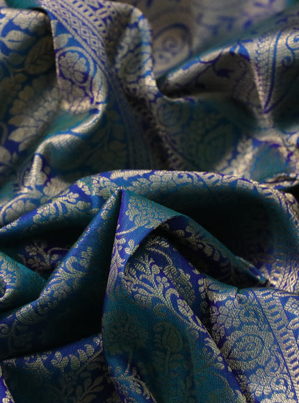 Pure kanchipuram silk saree dual shade of peacock blue with allover zari woven brocade weaves and long floral zari woven border