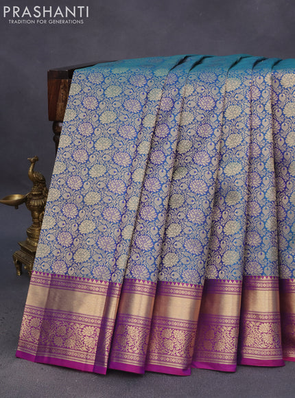 Pure kanchipuram silk saree dual shade of peacock blue and purple with allover zari woven floral brocade weaves and floral zari woven border