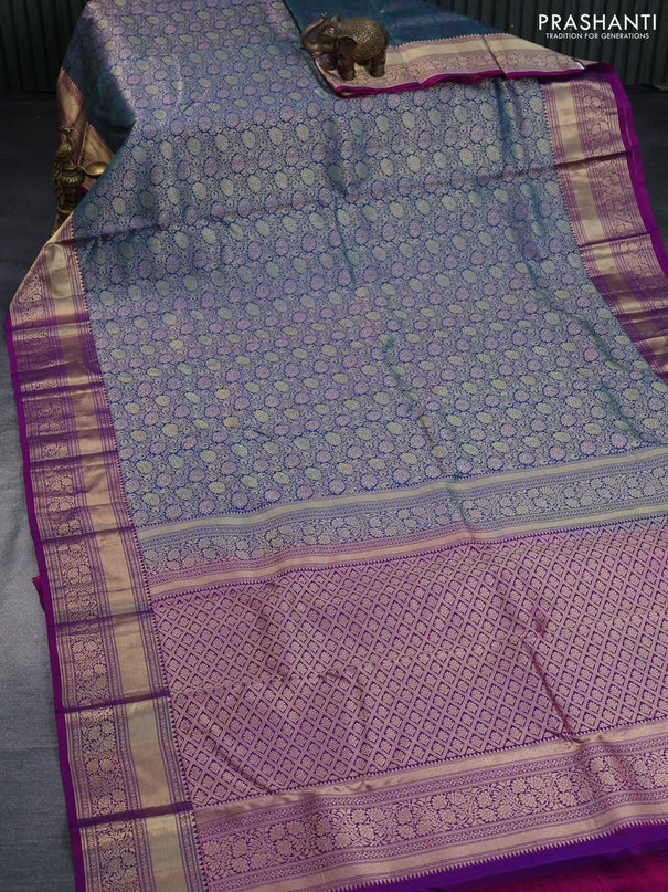 Pure kanchipuram silk saree dual shade of peacock blue and purple with allover zari woven floral brocade weaves and floral zari woven border