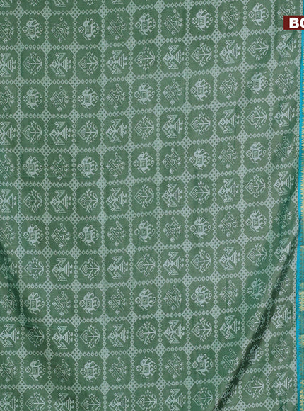 Semi tussar saree green shade with allover patola prints and ikat woven zari border