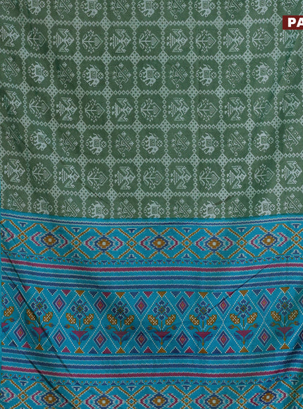 Semi tussar saree green shade with allover patola prints and ikat woven zari border