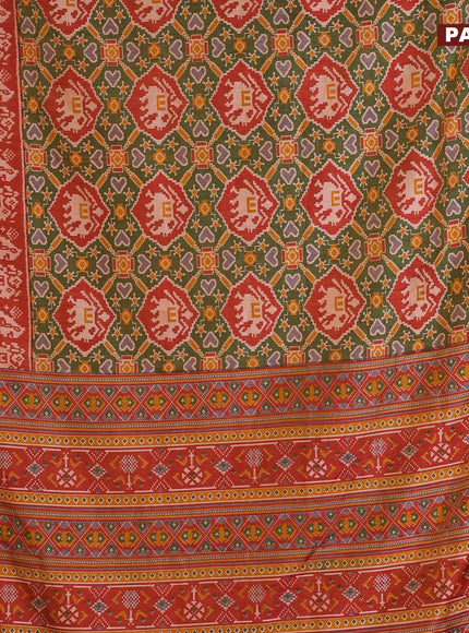 Semi tussar saree sap green and rust shade with allover patola prints and zari woven border