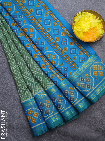 Semi tussar saree green and cs blue with allover ikat prints and ikat woven zari border