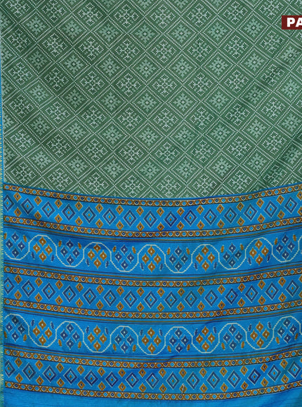 Semi tussar saree green and cs blue with allover ikat prints and ikat woven zari border