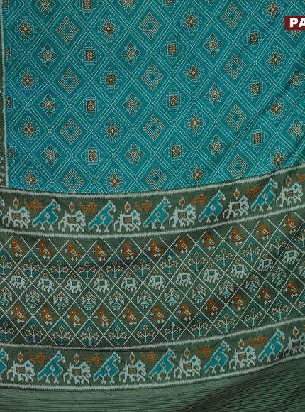 Semi tussar saree dual shade of teal blue and green with allover ikat prints and zari woven border