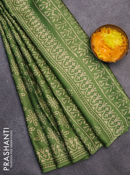 Modal silk saree green shade with allover prints and printed border