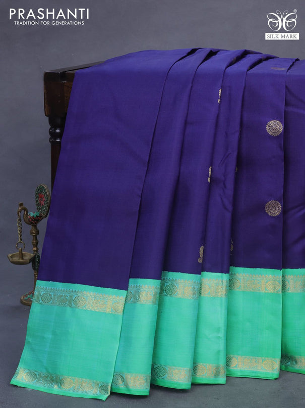 Pure kanchipuram silk saree dark blue and dual shade of teal bluish green with annam & rudhraksha zari woven buttas and rettapet zari woven korvai border