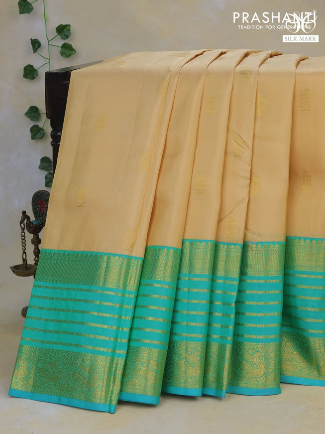 Pure kanchipuram silk saree cream and teal blue with annam zari woven buttas and long rich zari woven korvai border