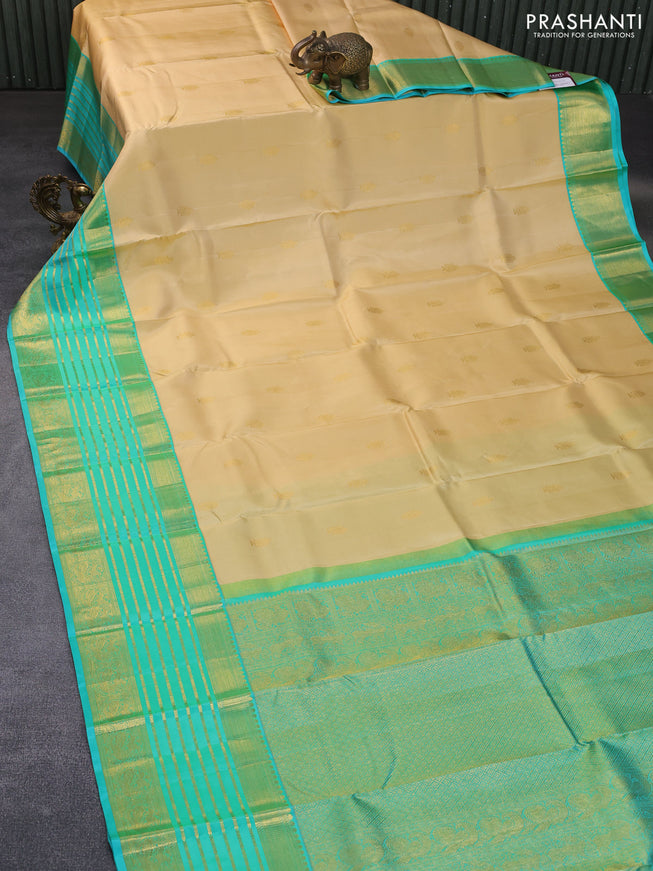 Pure kanchipuram silk saree cream and teal blue with annam zari woven buttas and long rich zari woven korvai border