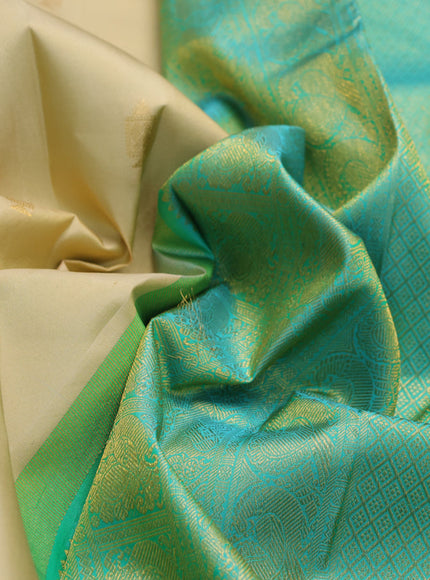 Pure kanchipuram silk saree cream and teal blue with annam zari woven buttas and long rich zari woven korvai border