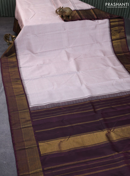 Pure kanchipuram silk saree beige shade and wine shade with allover checked pattern and temple design zari woven border