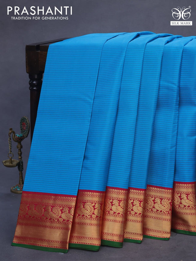 Pure kanchipuram silk saree cs blue and dark pink green with allover stripes pattern and annam zari woven korvai border